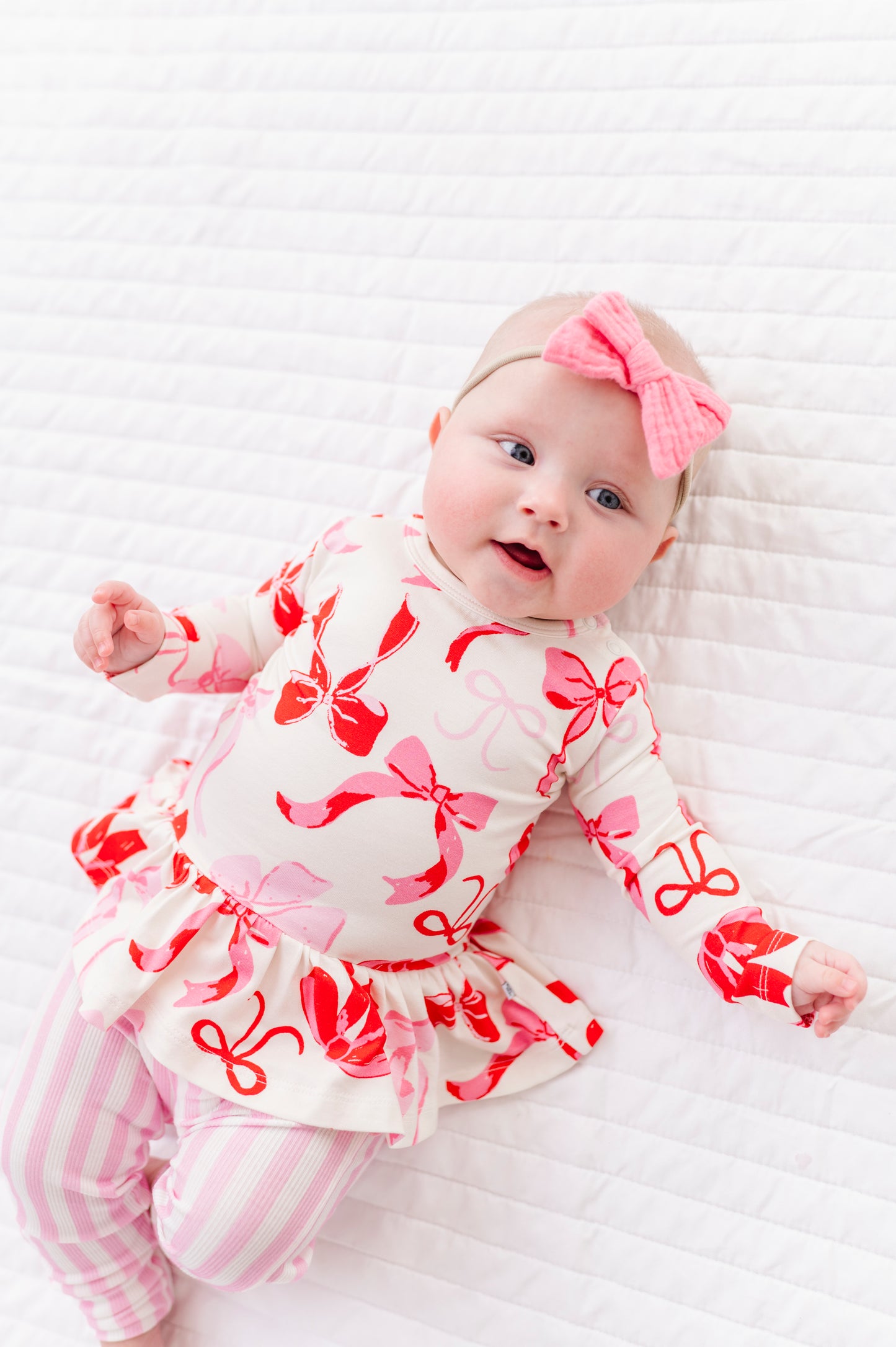 Baby lounging in pink stripe bamboo leggings 