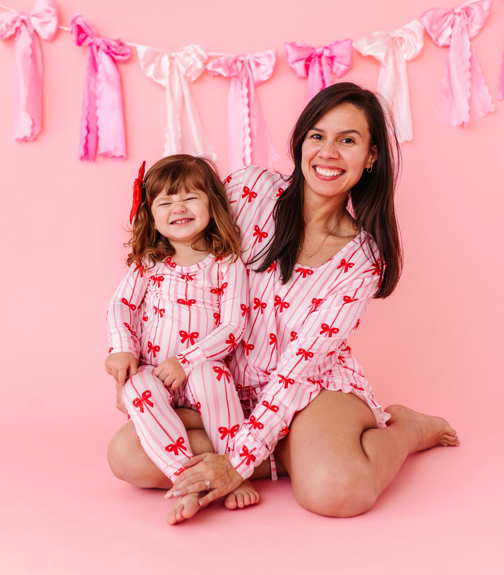 Matching mama and mini bamboo pajamas featuring Ruby Ribbons bow print