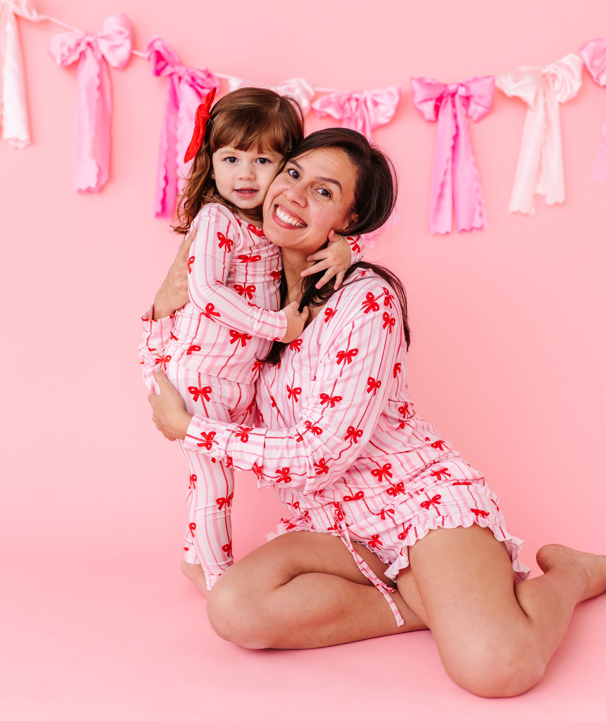 Matching mama and mini bamboo pajamas featuring Ruby Ribbons bow print