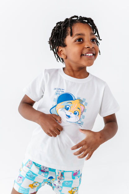 Child wearing a white t-shirt with a 44 Cats graphic design and colorful 44 Cats bamboo blend shorts on a white background