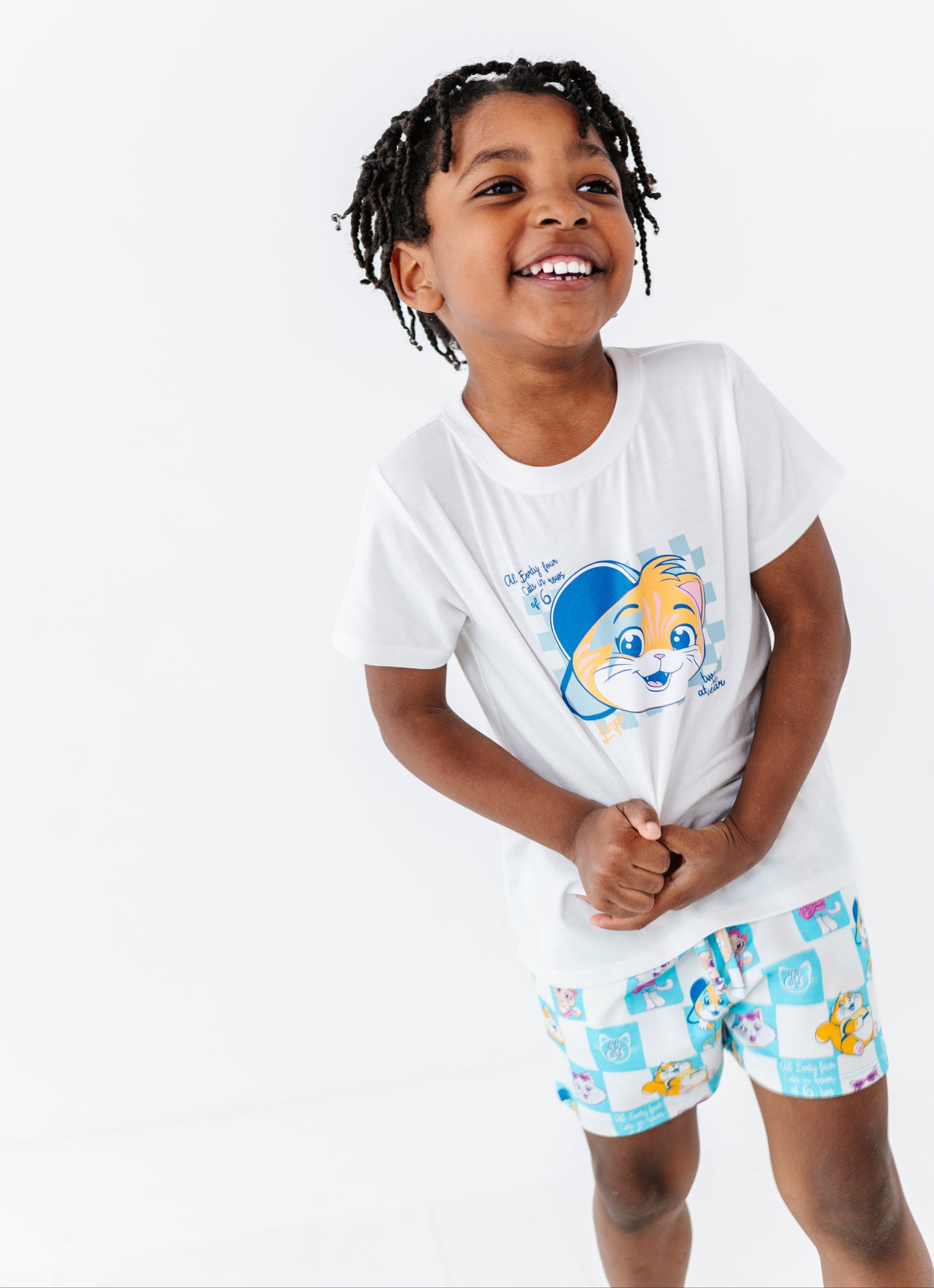 Child wearing a white 44 Cats t-shirt and matching 44 Cats bamboo blend shorts on a white background