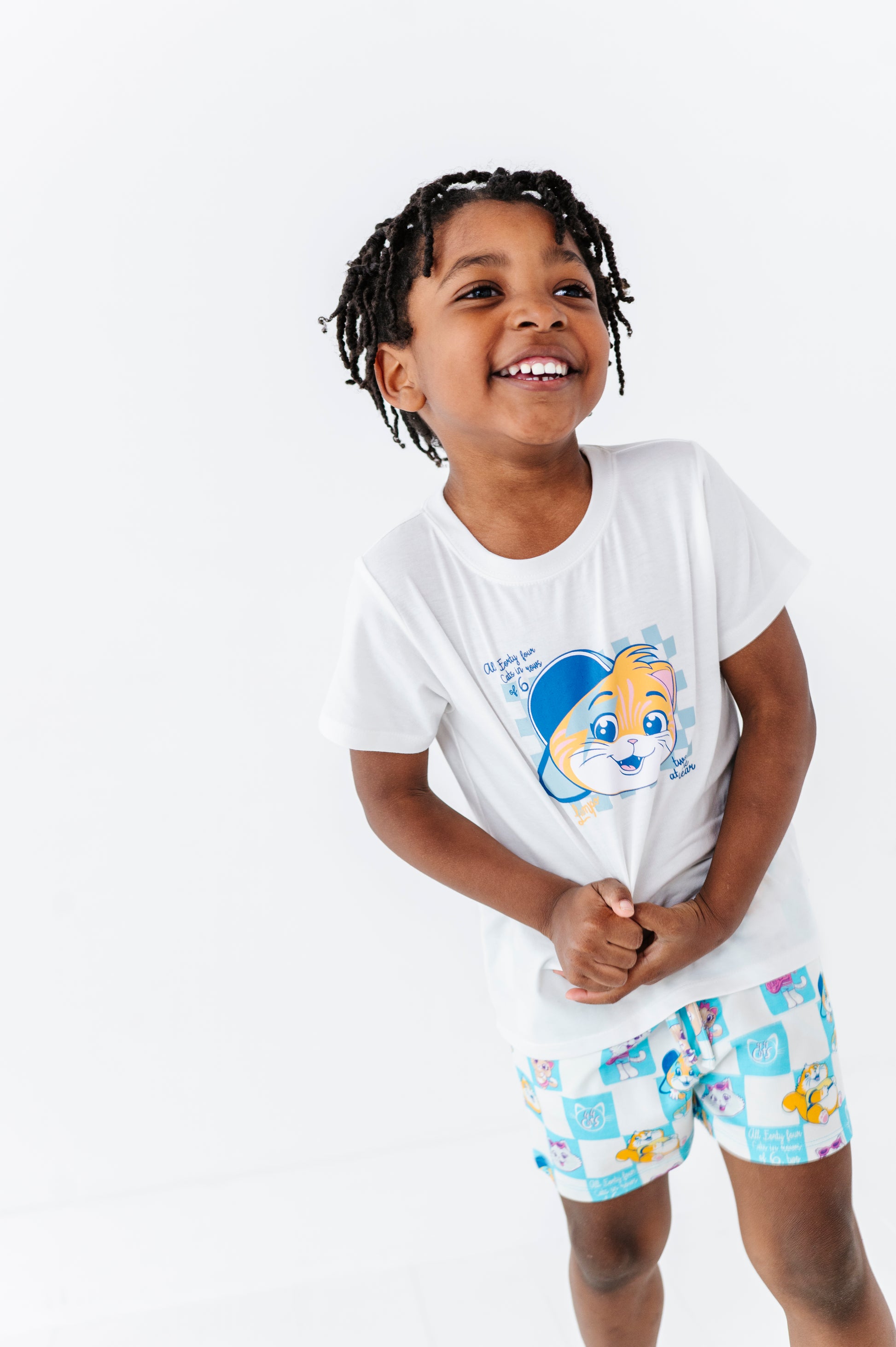 Child wearing a white 44 Cats t-shirt and matching checkered shorts on a white background