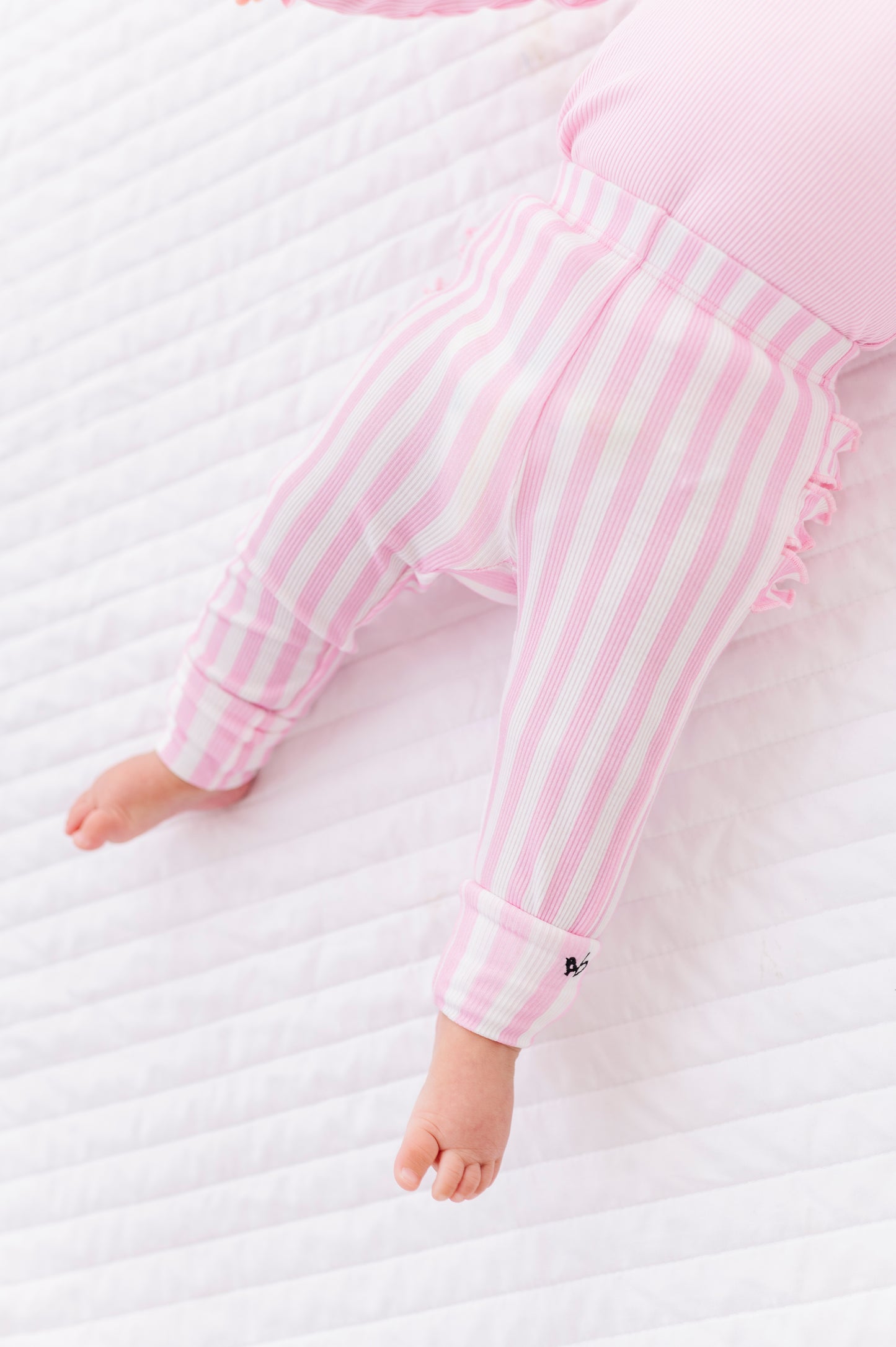 Close-up of pink striped ribbed leggings made from bamboo fabric