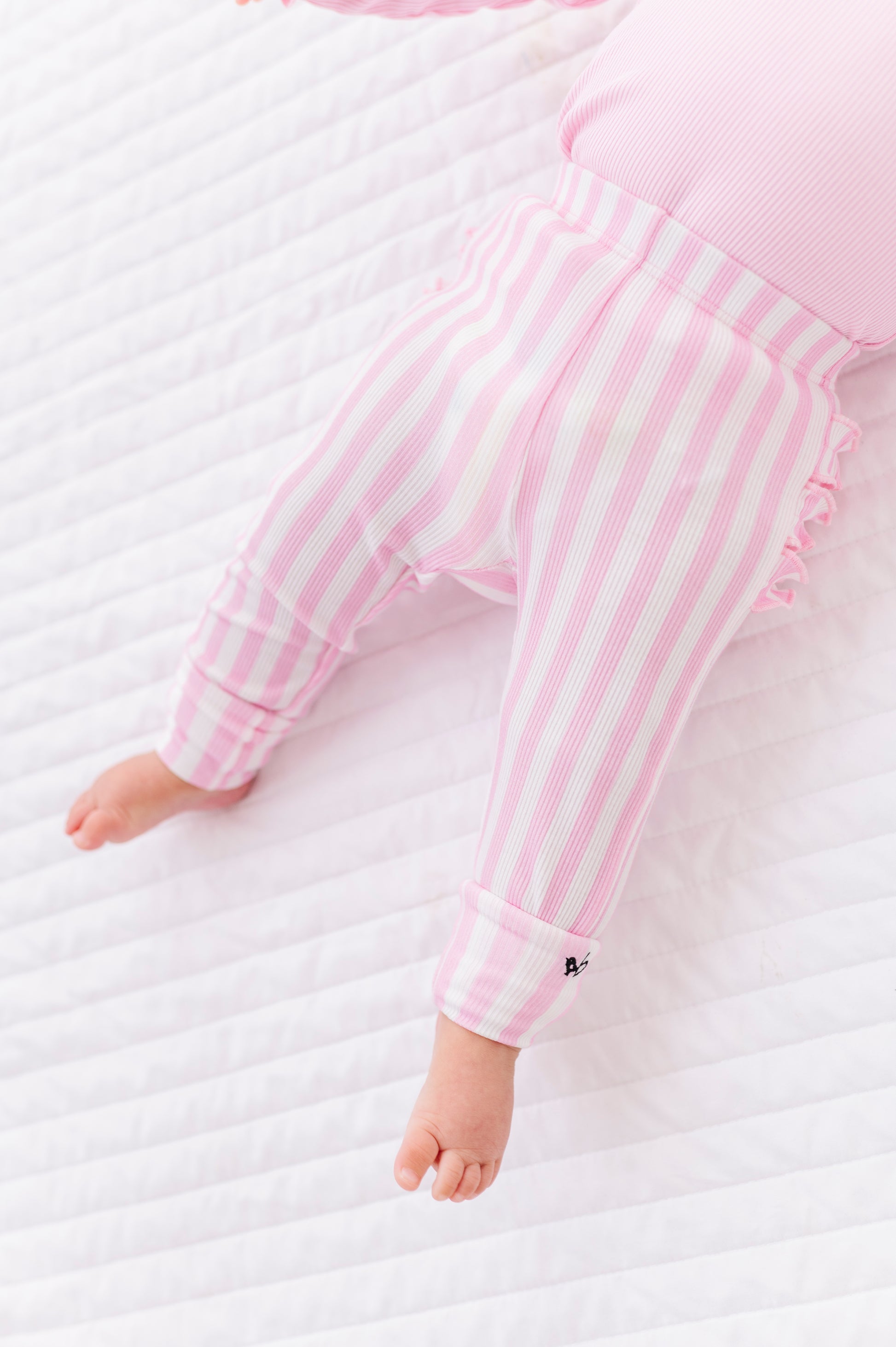 Close-up of pink striped ribbed leggings made from bamboo fabric