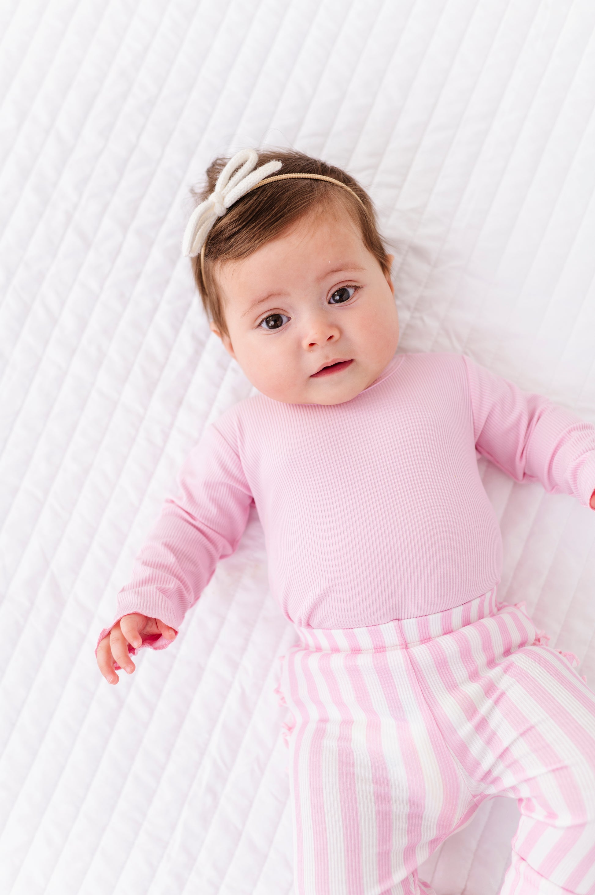 Child wearing pink stripe bamboo leggings with elastic waistband