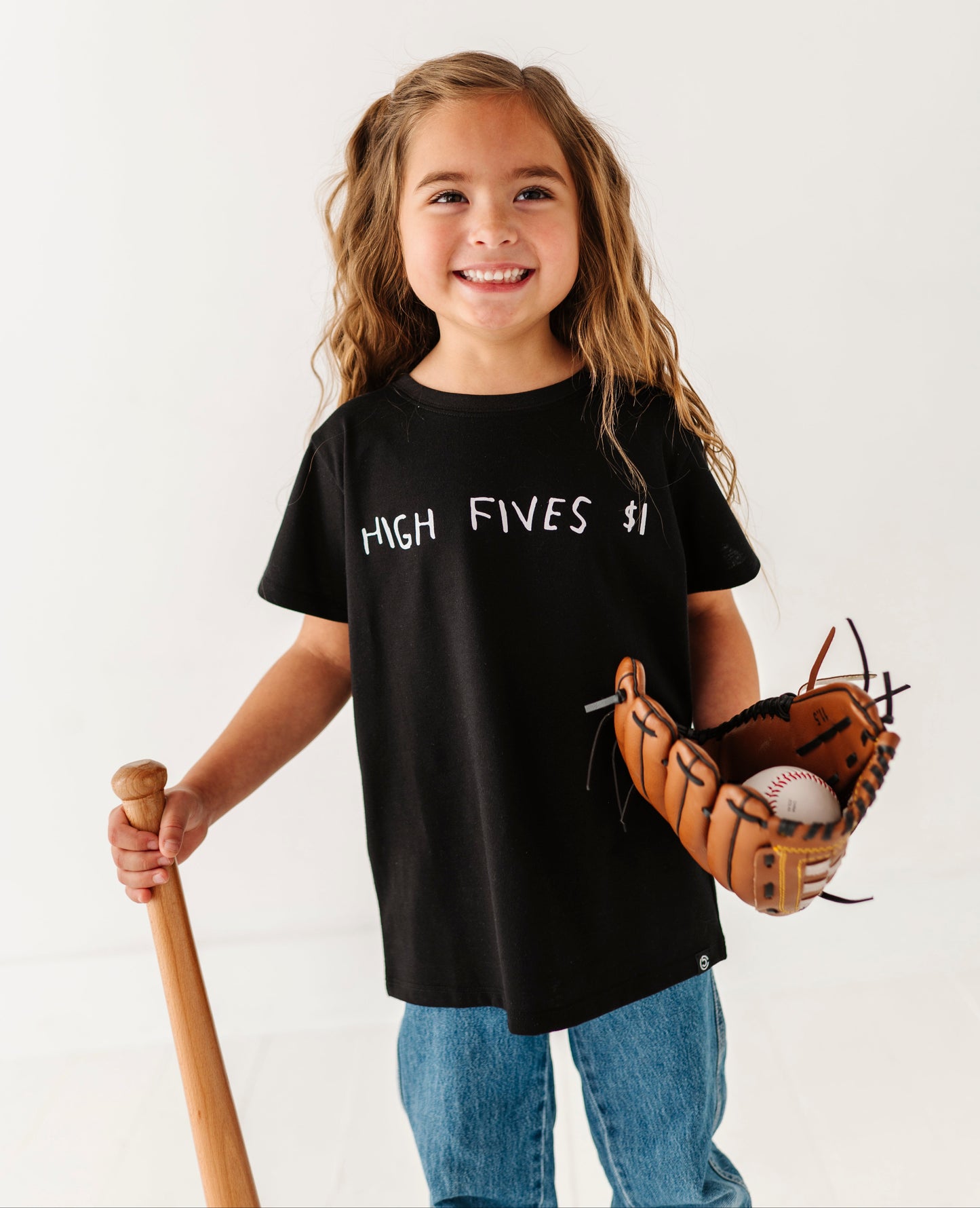 Child wearing a black t-shirt with 'High Fives' text, holding a baseball bat and glove on a white background
