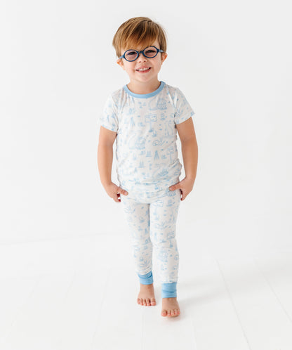 Child wearing a patterned pajama set on a white background