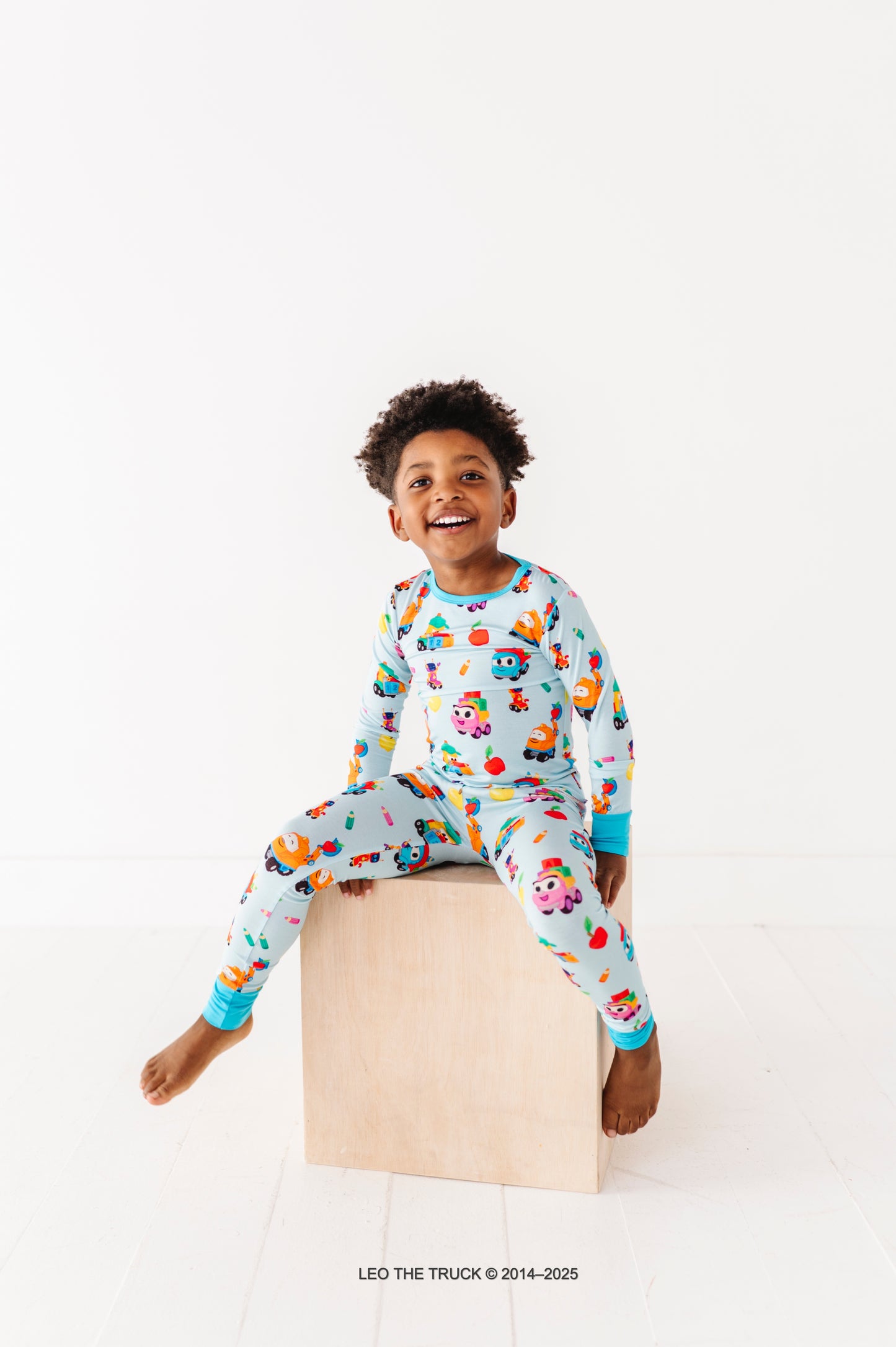 Little boy wearing hypoallergenic bamboo pajamas featured Leo the Truck 