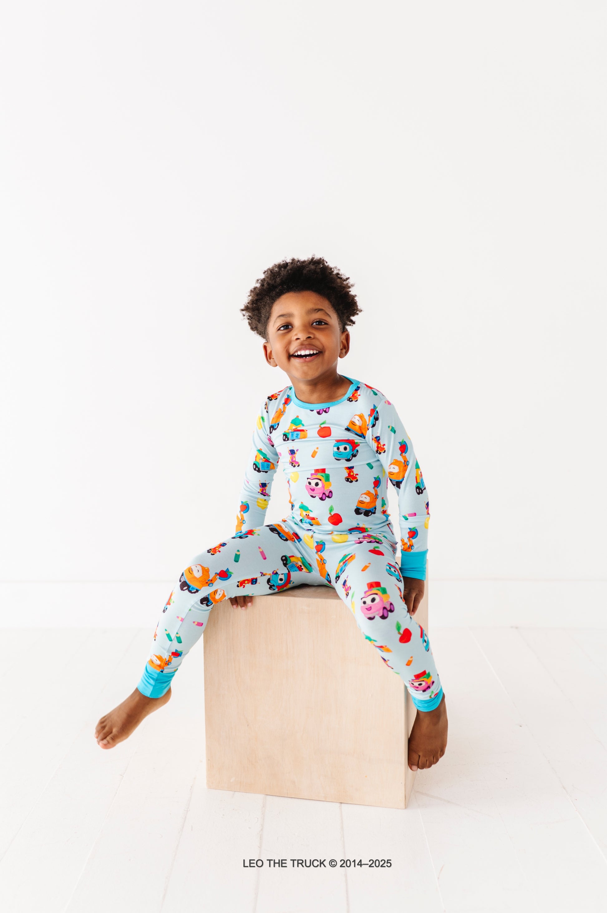 Little boy wearing hypoallergenic bamboo pajamas featured Leo the Truck 