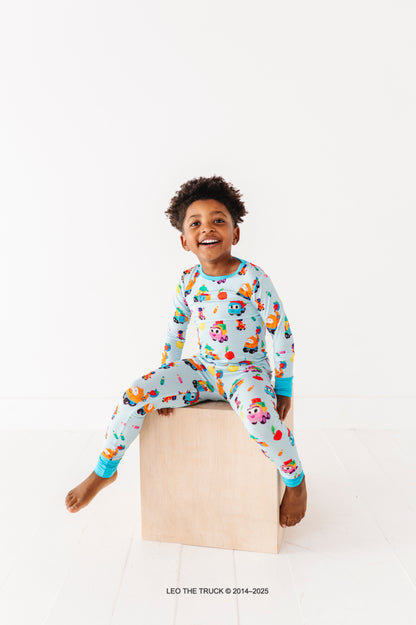 Little boy wearing hypoallergenic bamboo pajamas featured Leo the Truck 