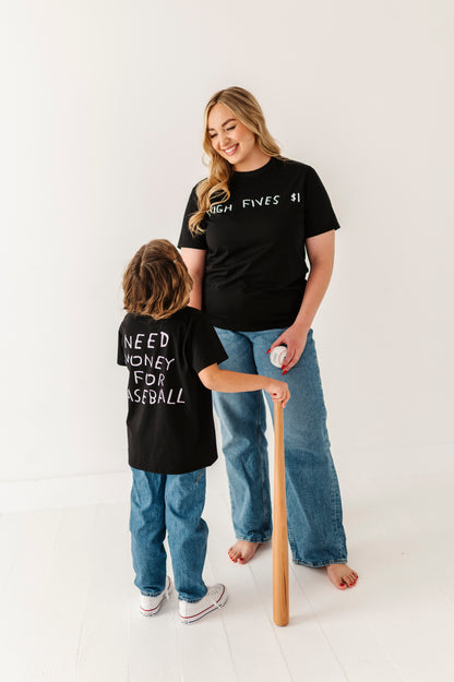 Woman and child wearing black t-shirts with text, standing on a white background