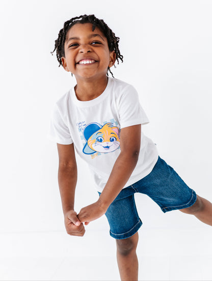 Child wearing a white 44 Cats t-shirt and denim shorts on a white background