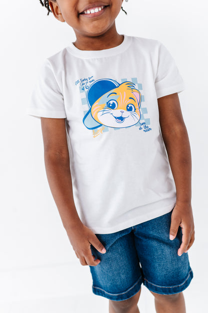 Child wearing a white 44 Cats t-shirt featuring Lampo and denim shorts on a white background