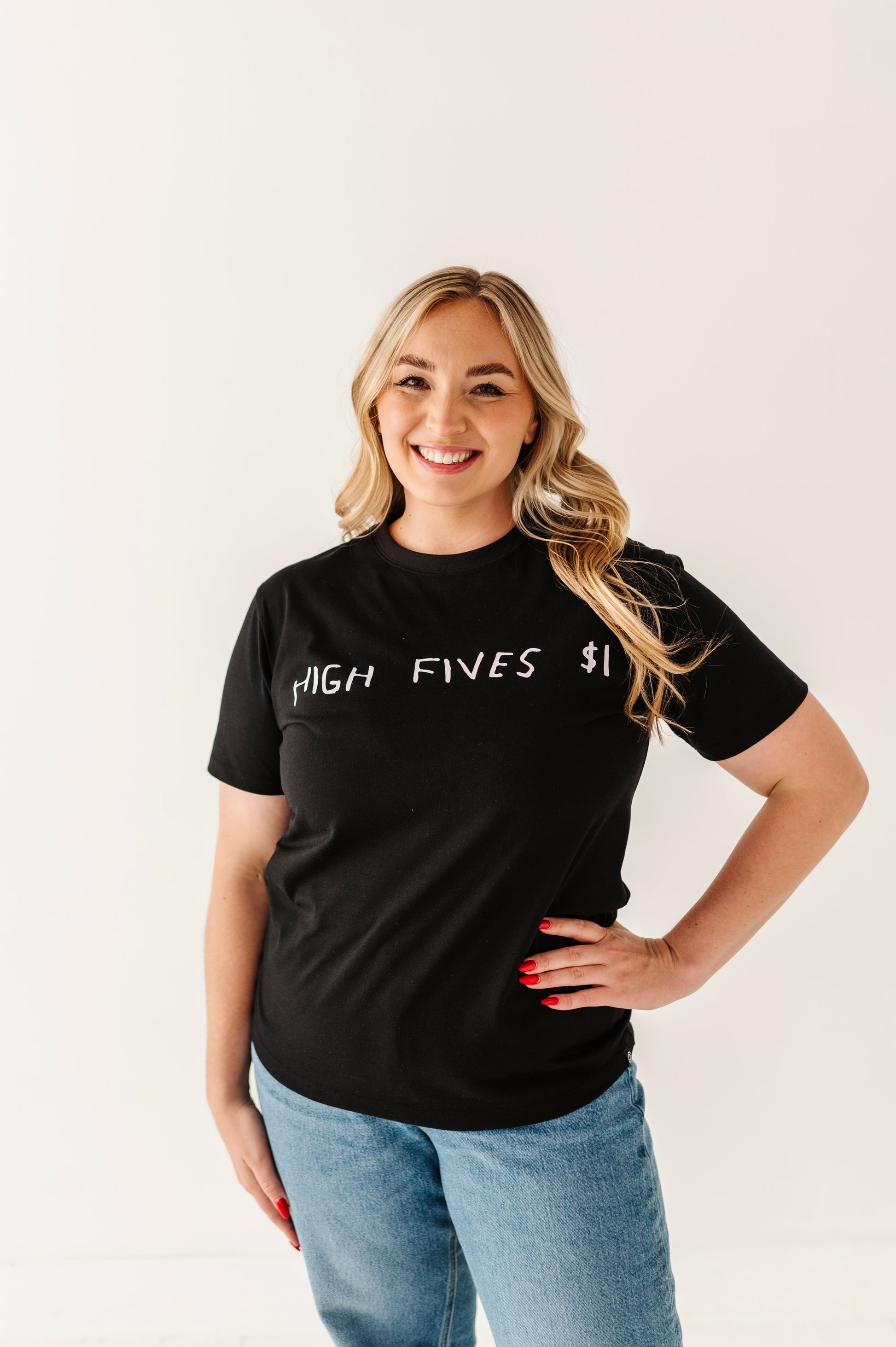 Woman wearing a black t-shirt with 'HIGH FIVES $1' text on a plain background
