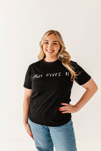 Woman wearing a black t-shirt with 'HIGH FIVES $1' text on a plain background