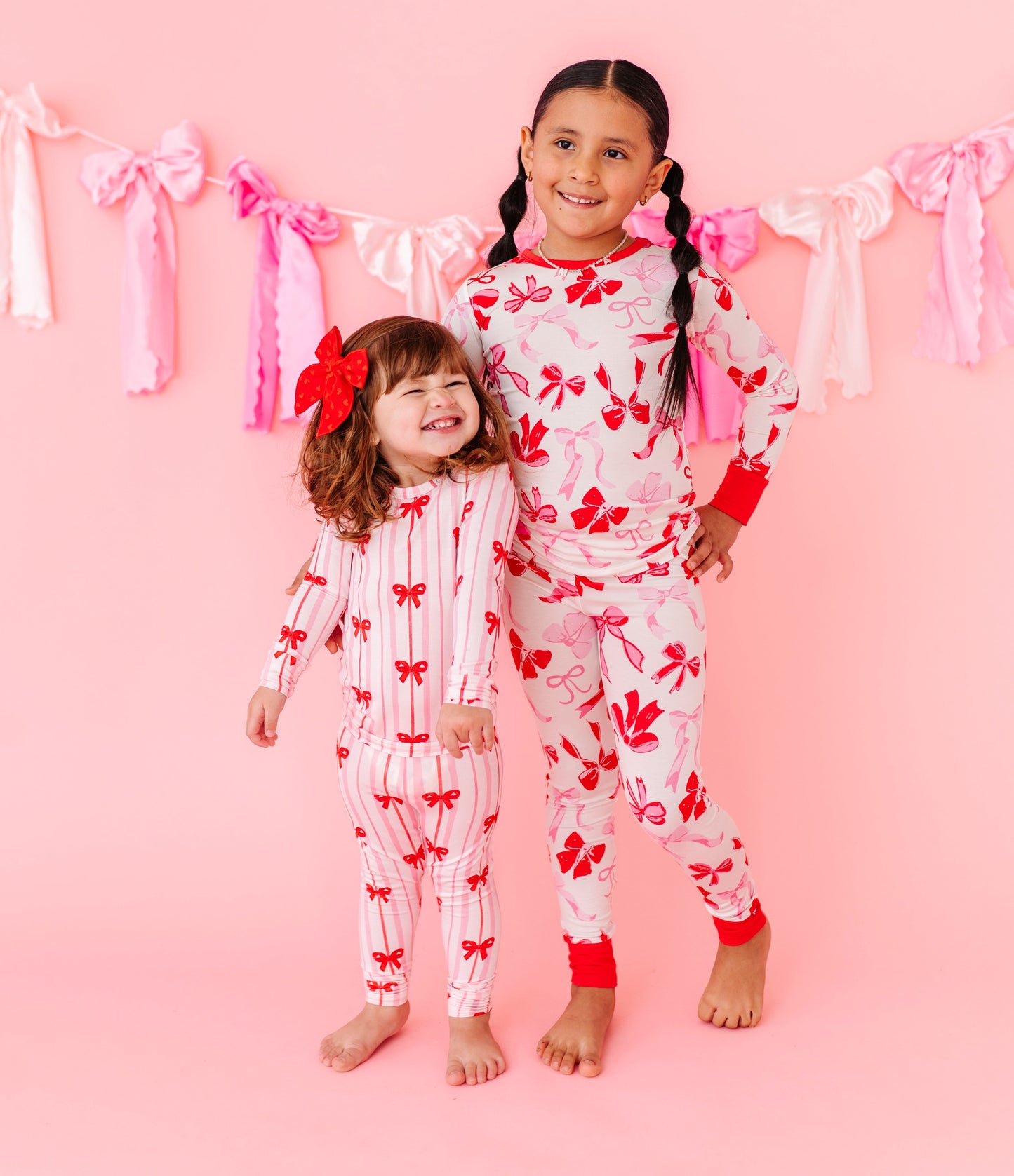 Coordinating bamboo pajamas featuring red and pink bow prints