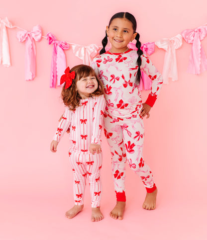 Coordinating bamboo pajamas featuring red and pink bow prints
