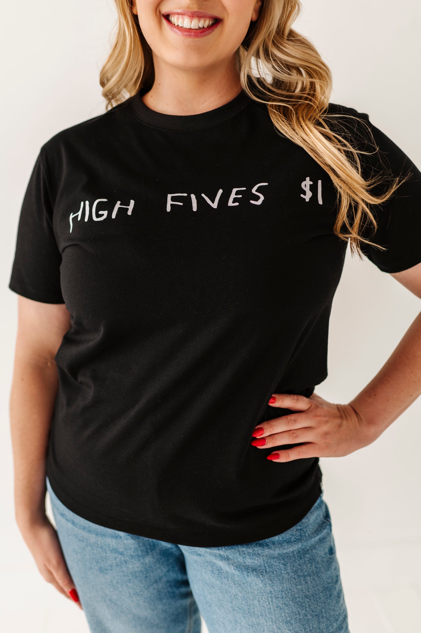 Person wearing a black t-shirt with 'HIGH FIVES $1' text on a plain background
