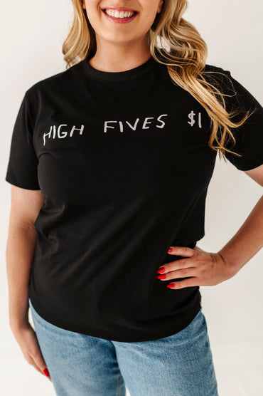 Person wearing a black t-shirt with 'HIGH FIVES $1' text on a plain background