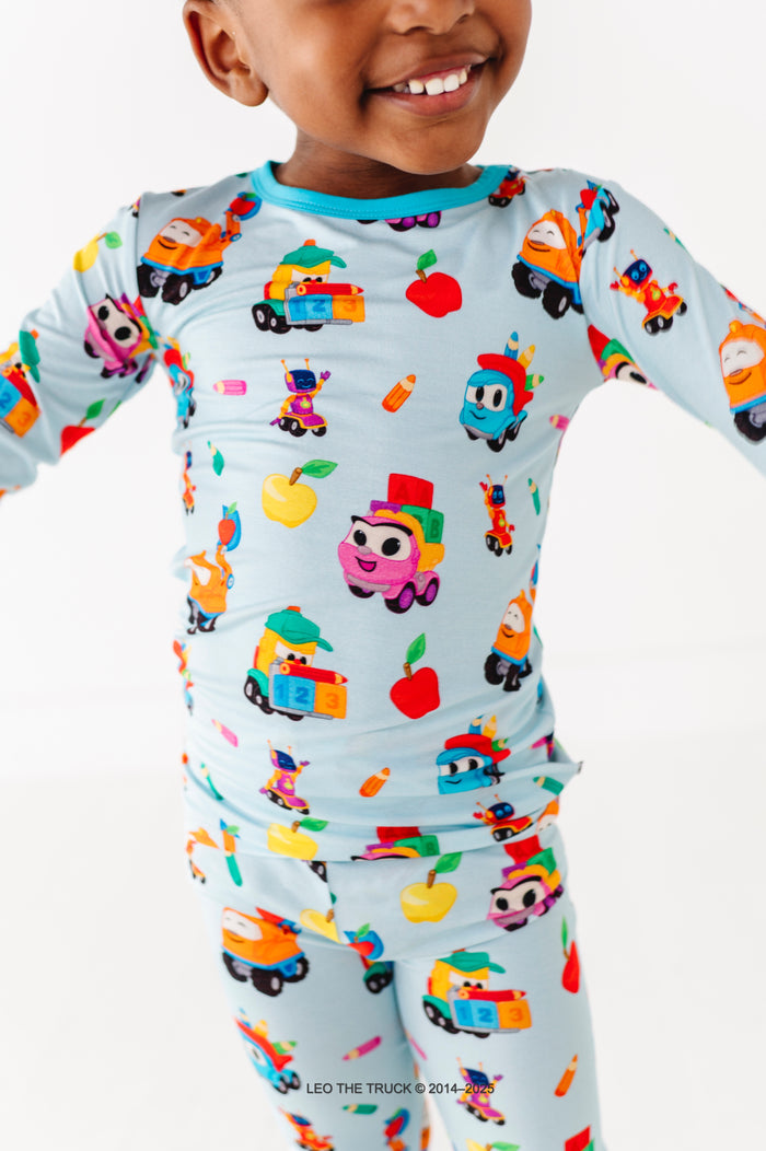Close-up shot of Leo the Truck bamboo pajamas on a little boy against a white background 