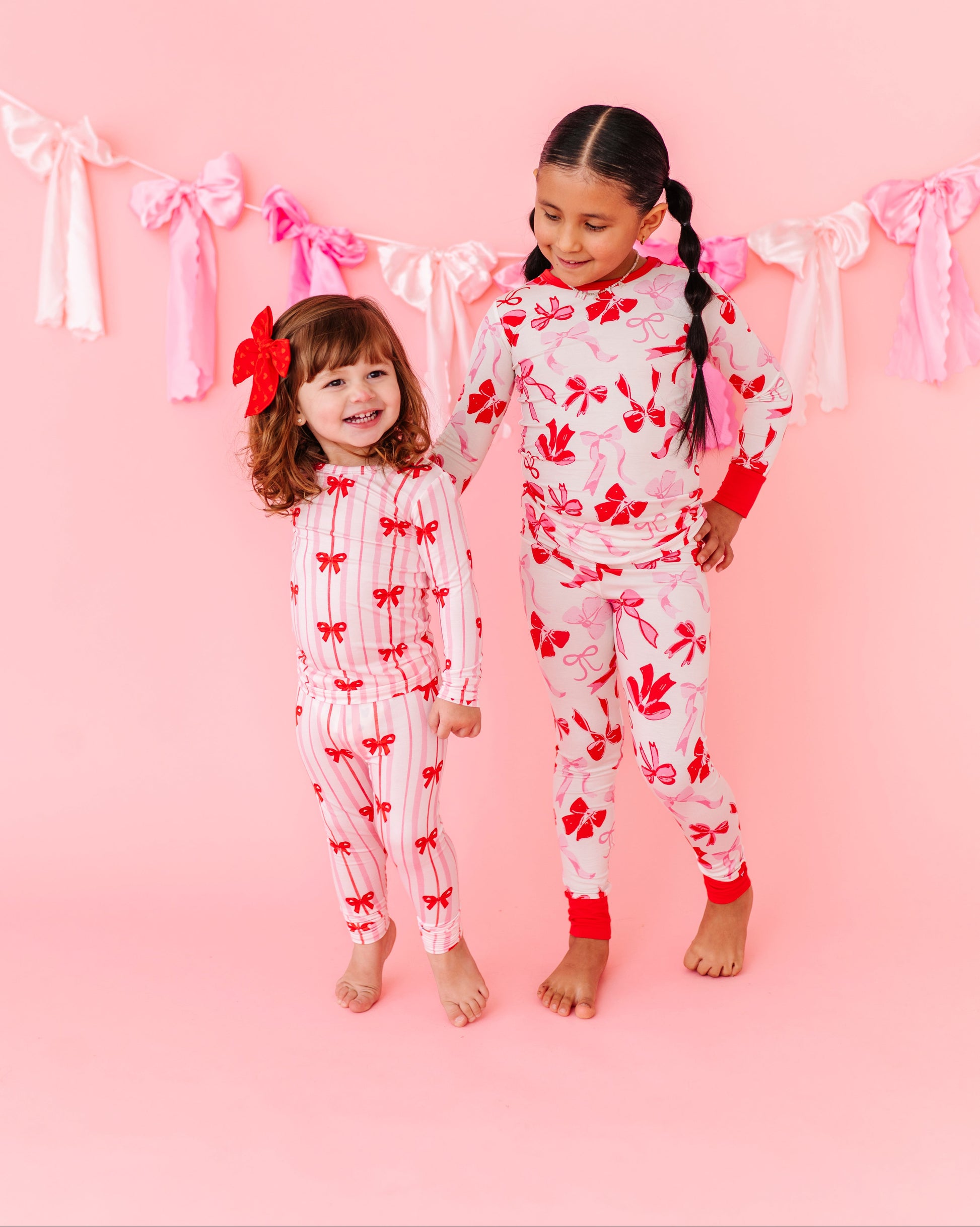 Girls wearing Birdie Bean Blushing Bows bamboo pajamas together