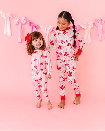 Girls wearing Birdie Bean Blushing Bows bamboo pajamas together