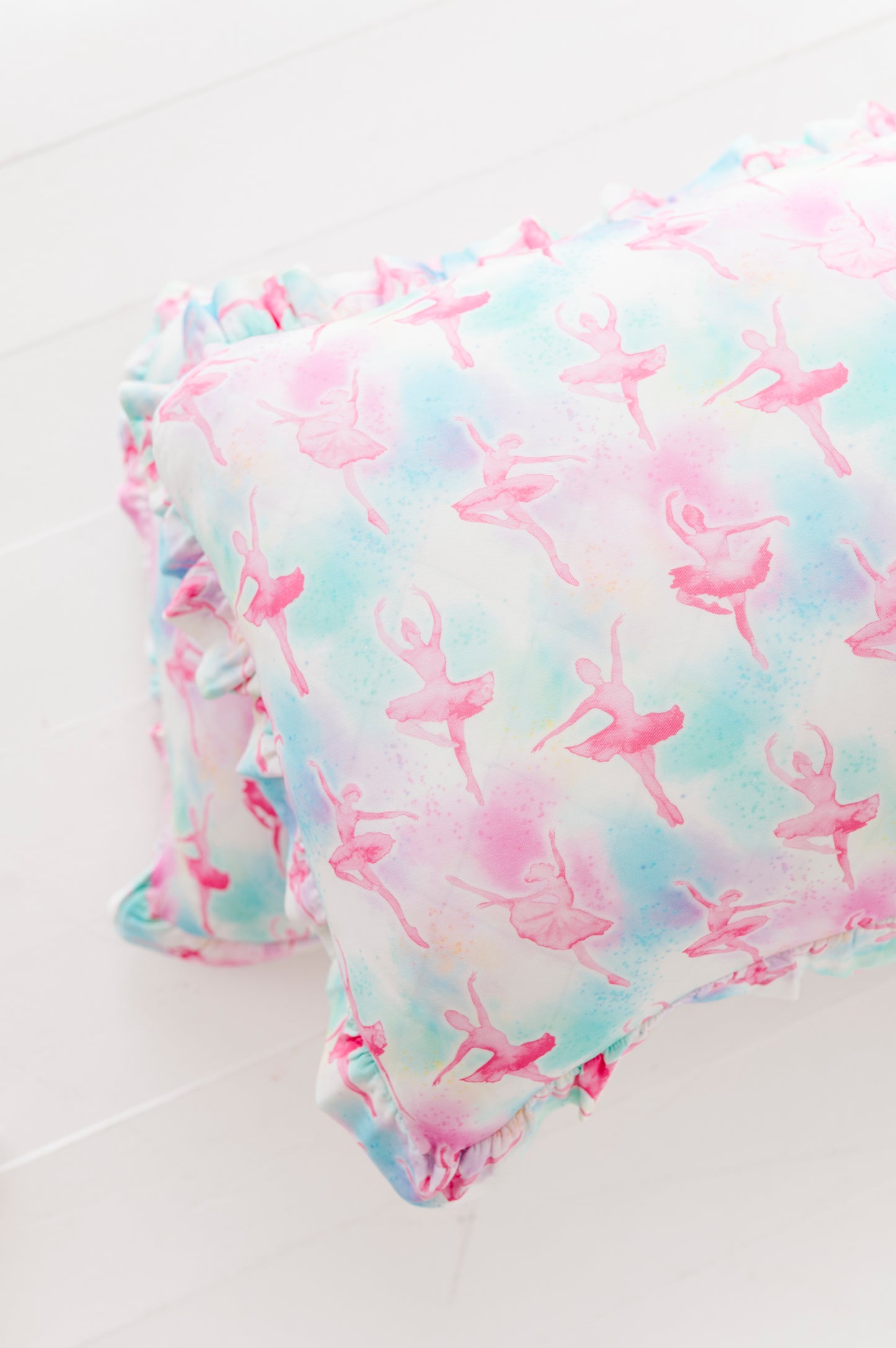 Ballerina patterned bamboo fabric with pink and blue colors on a white background