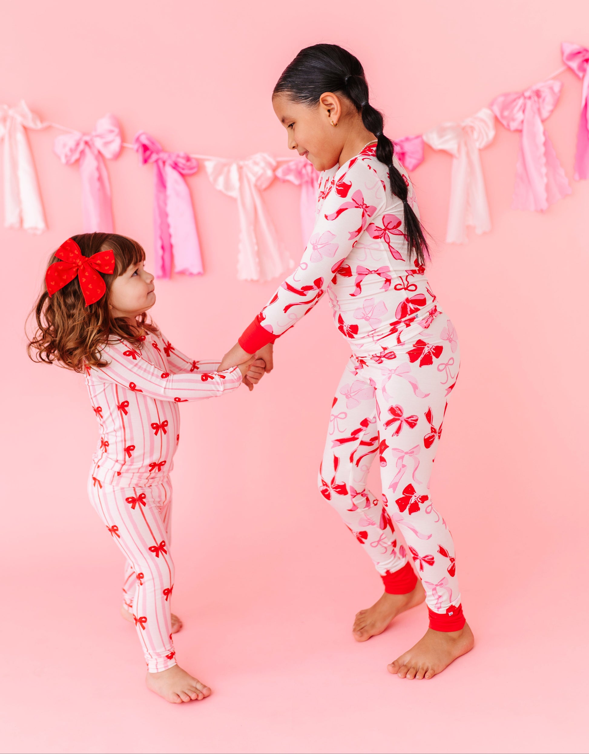 Kids bamboo pajamas with blush and red bow print by Birdie Bean