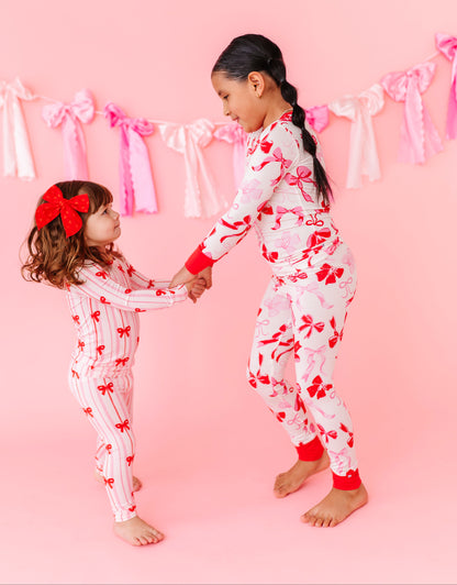 Kids bamboo pajamas with blush and red bow print by Birdie Bean