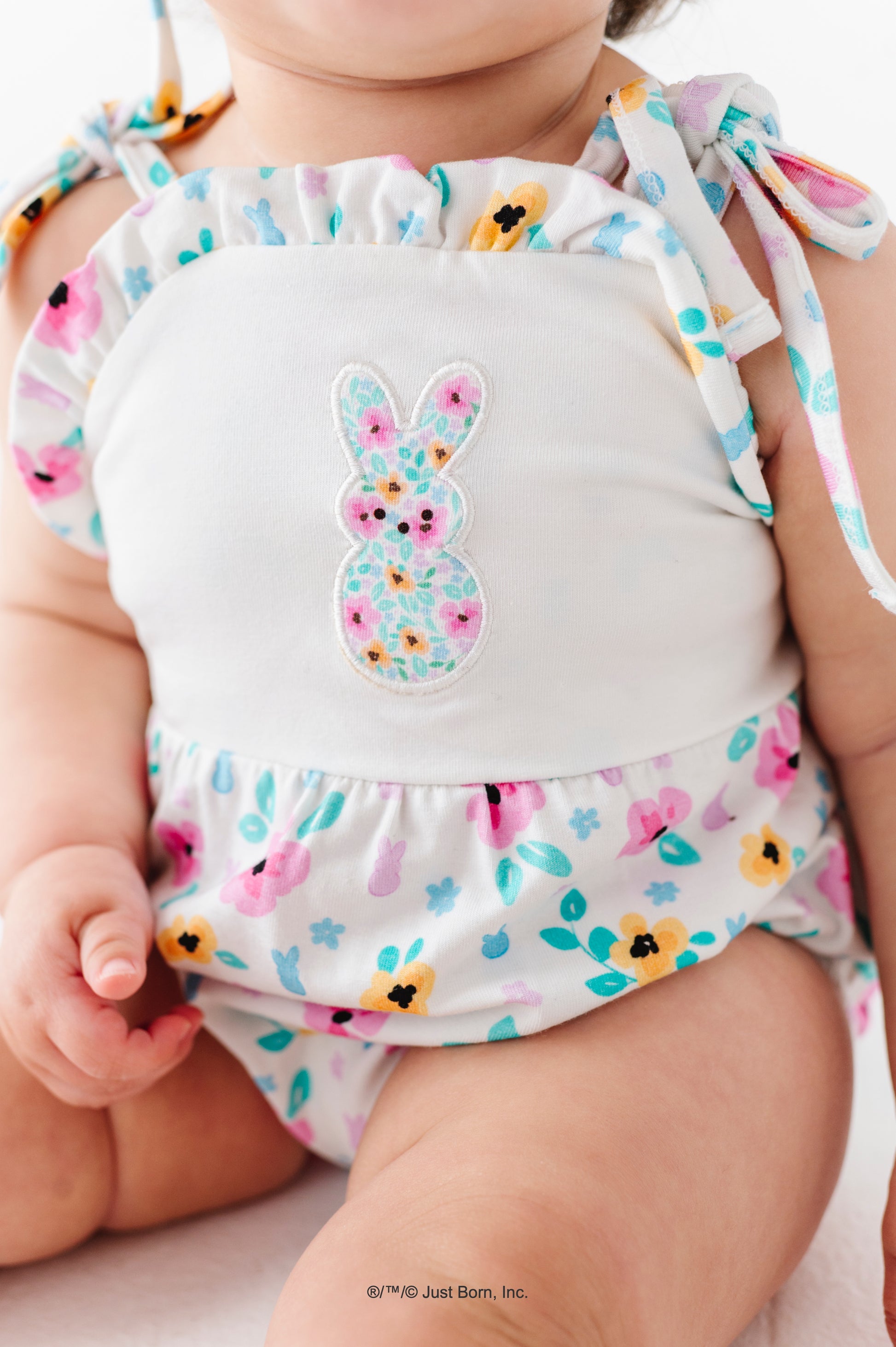 Baby outfit with colorful PEEPS® design and bunny illustration on a plain background