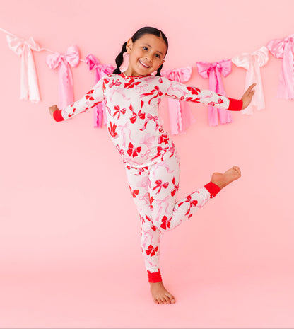 Kids bamboo pajamas with blush and red bow print by Birdie Bean