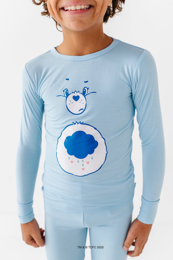 Close-up of Grumpy Bear pajama top showing cloud belly badge detail