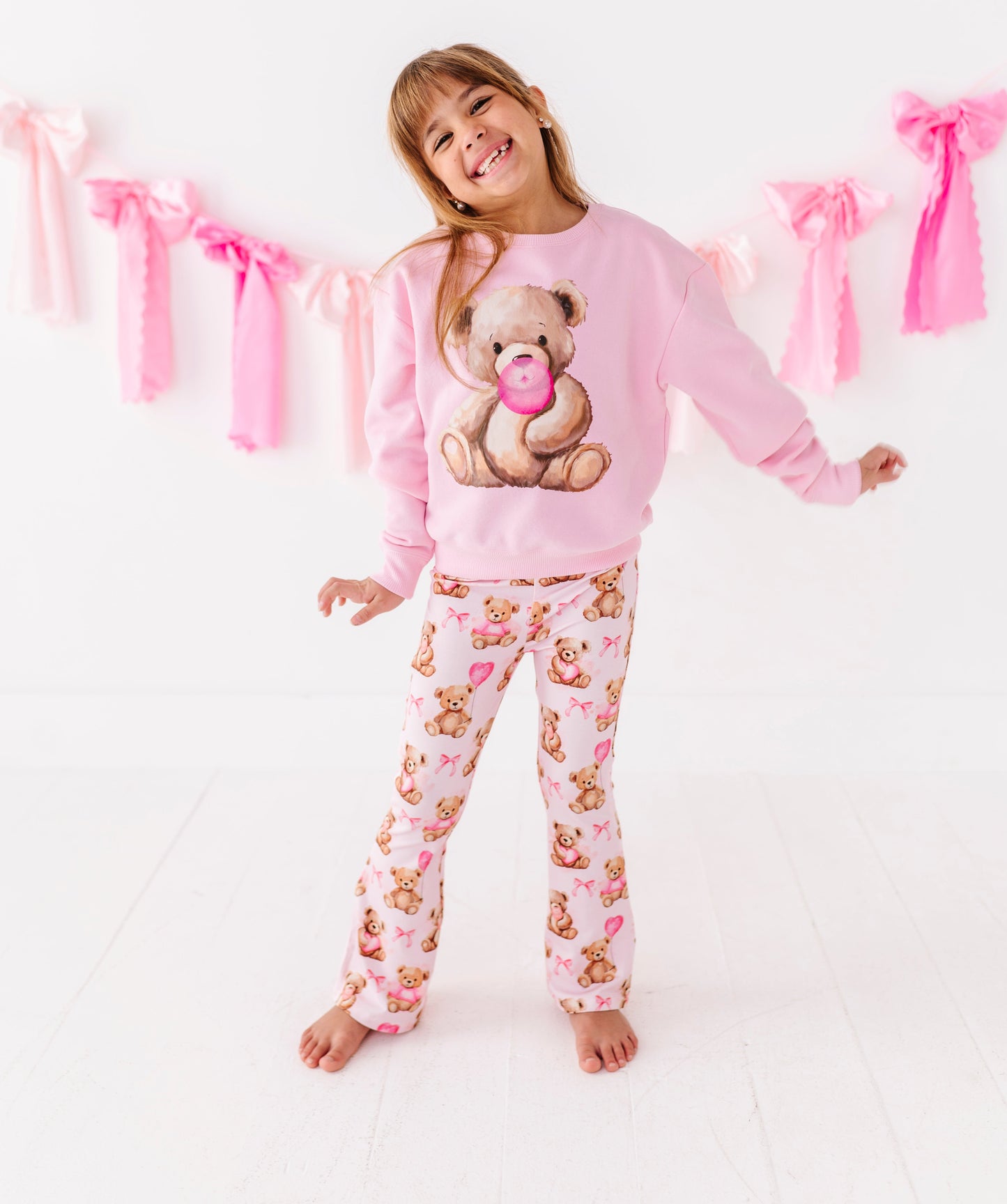 Child wearing pink teddy bear crewneck sweatshirt from Birdie Bean