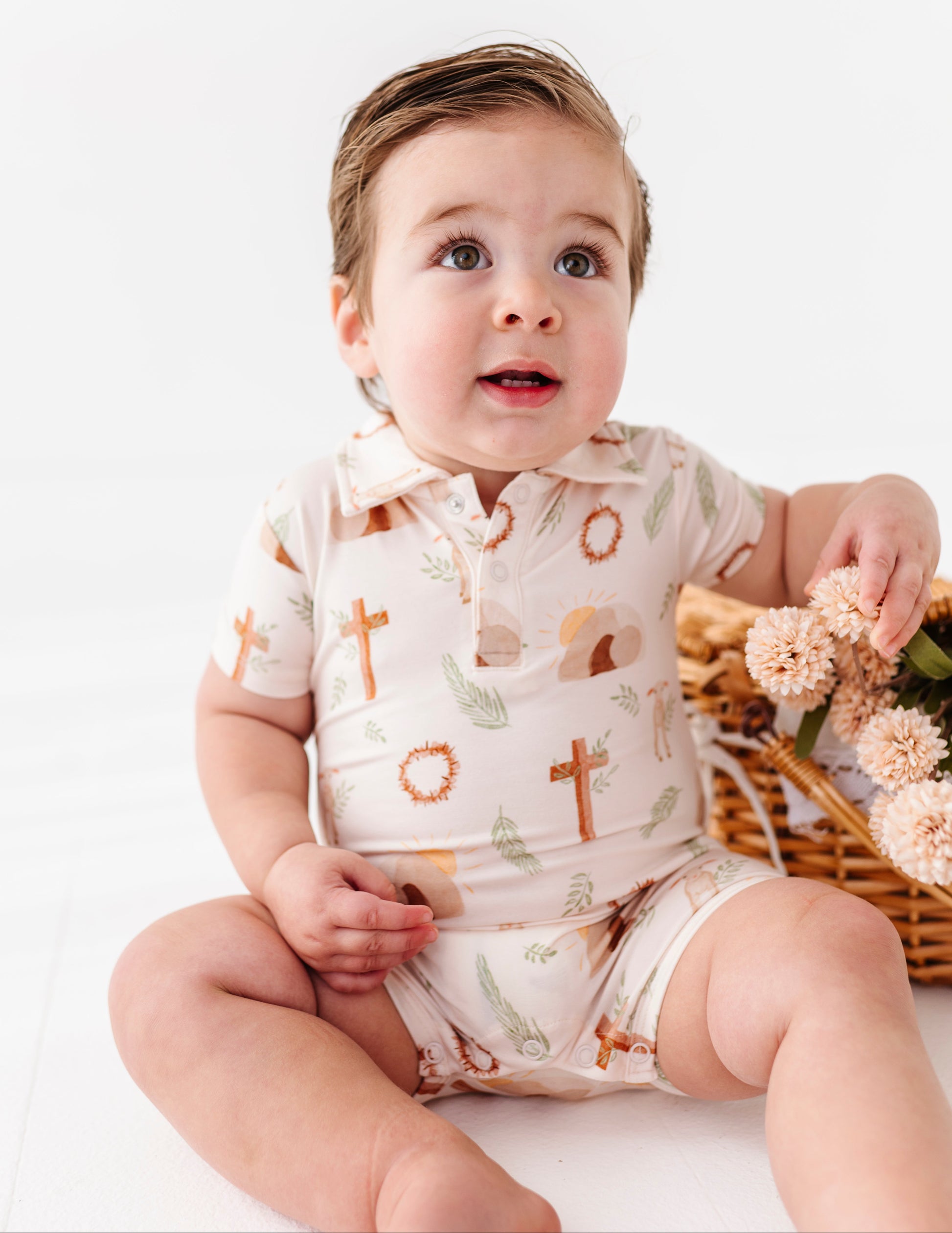 Baby wearing a Christian-focused bamboo outfit with a white background