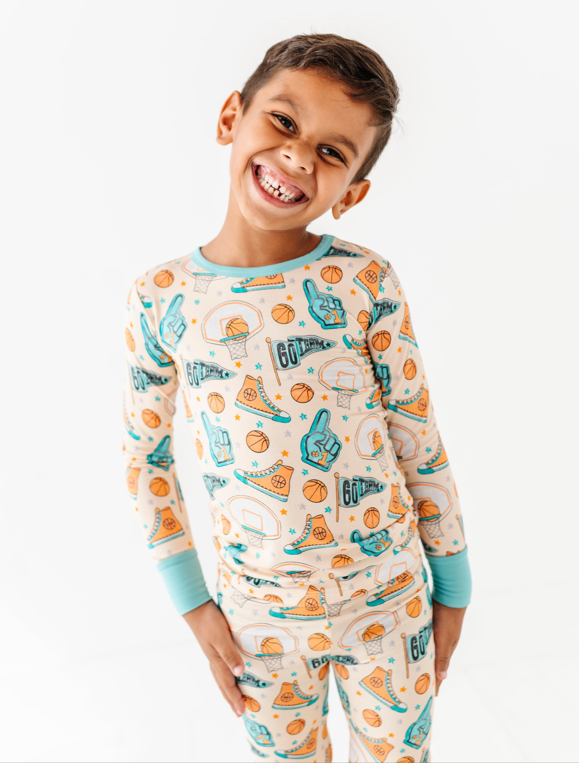 Child wearing a basketball bamboo pajama set on a white background