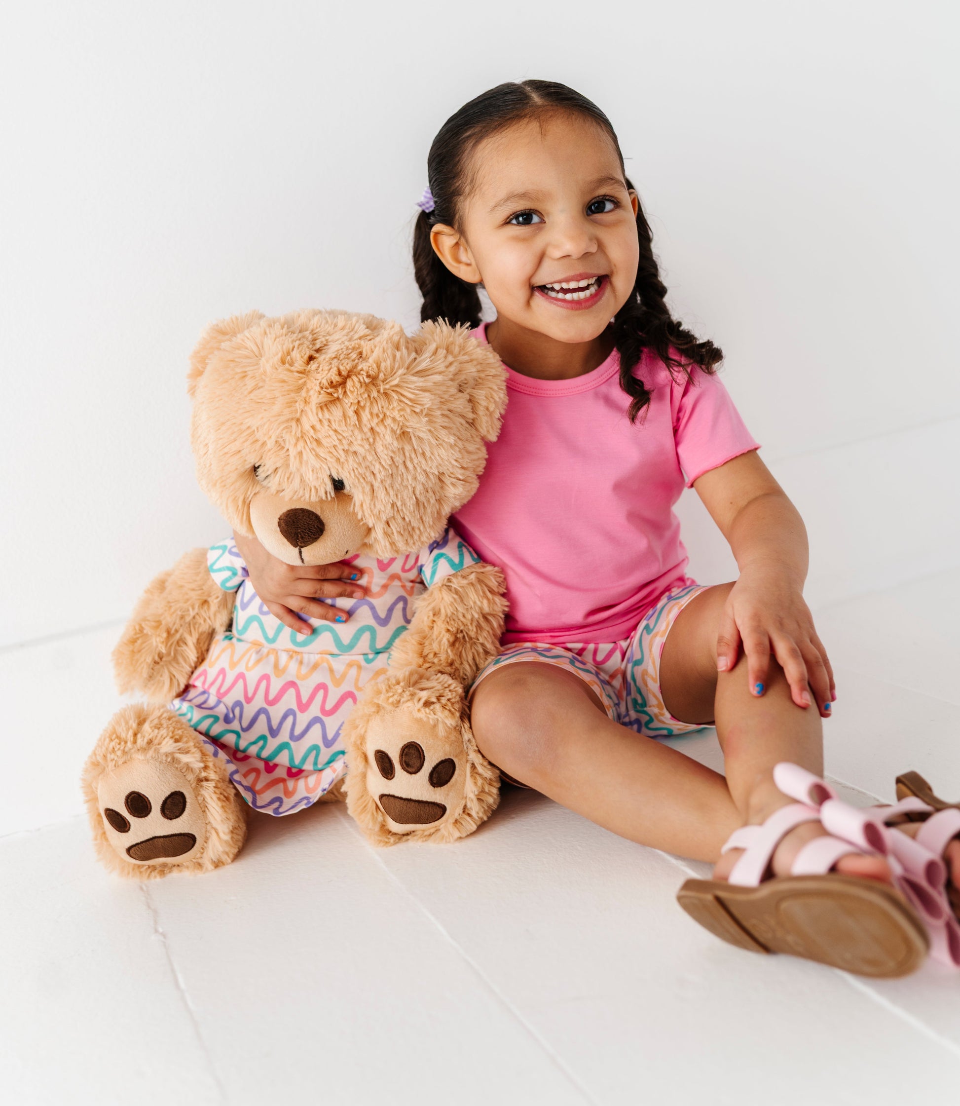 Little girl and her teddy bear wearing matching bamboo outfits