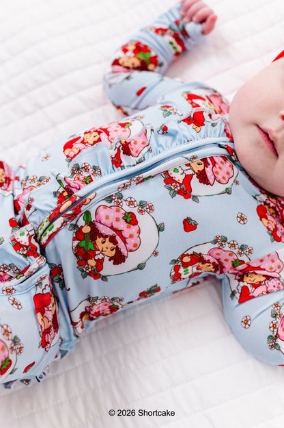 Baby wearing a Strawberry Shortcake™ bamboo convertible romper 