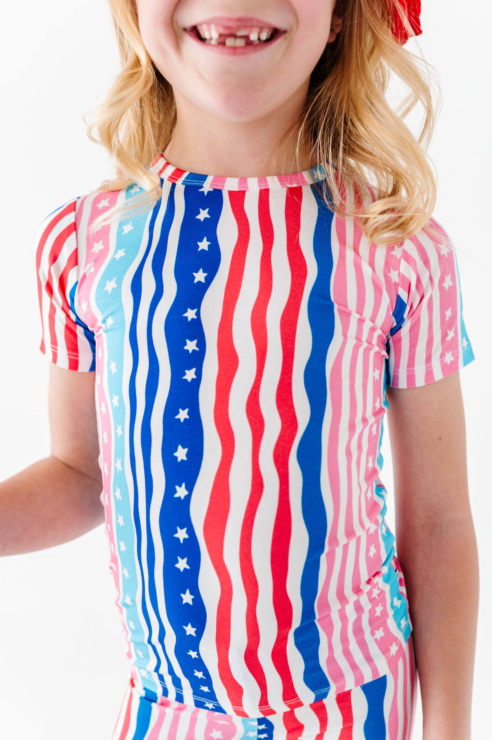 Child wearing a 4th of July bamboo pajama set on a white background