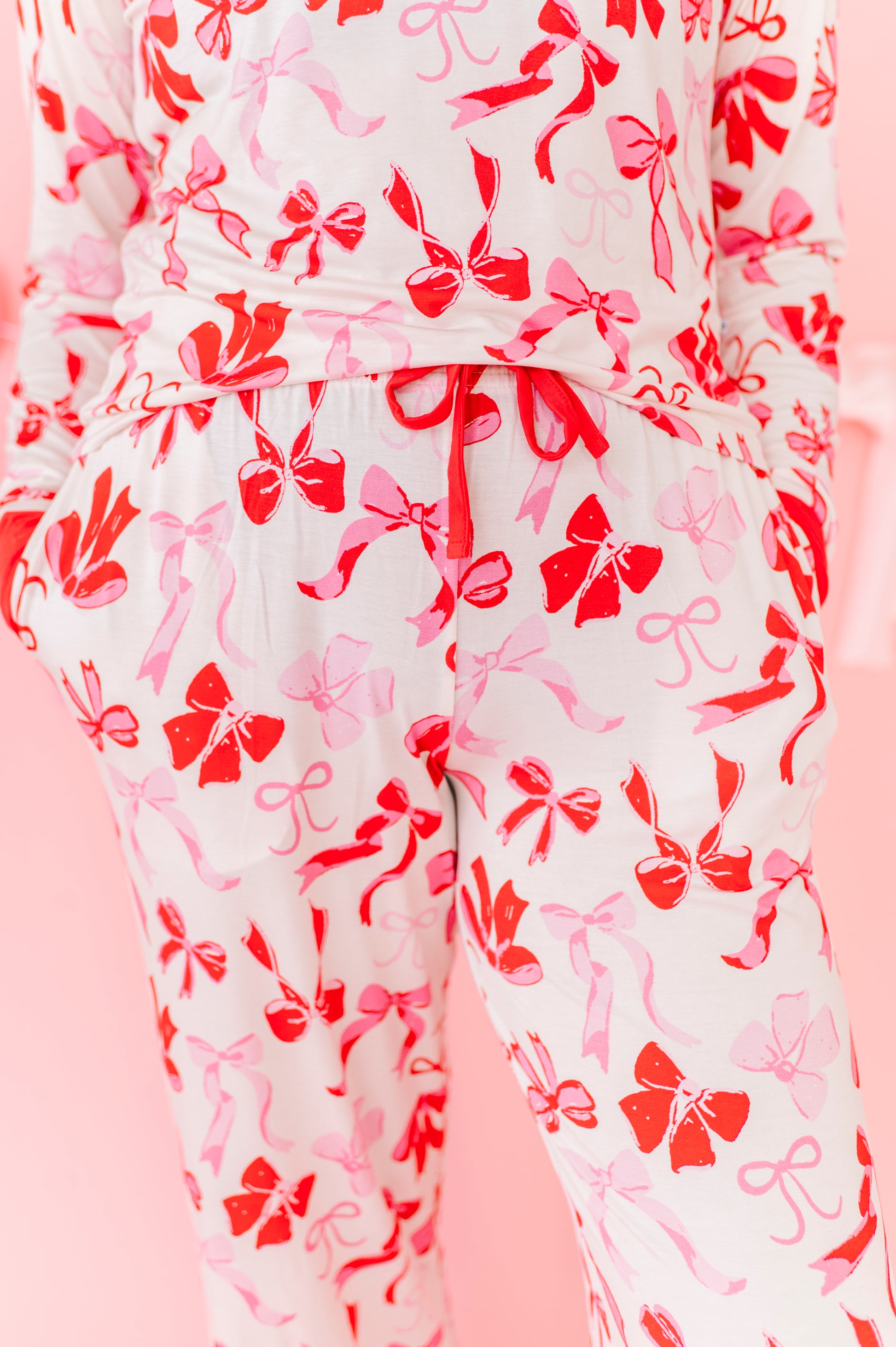 Close-up of women’s bamboo pajama bottoms with bow pattern and button neckline