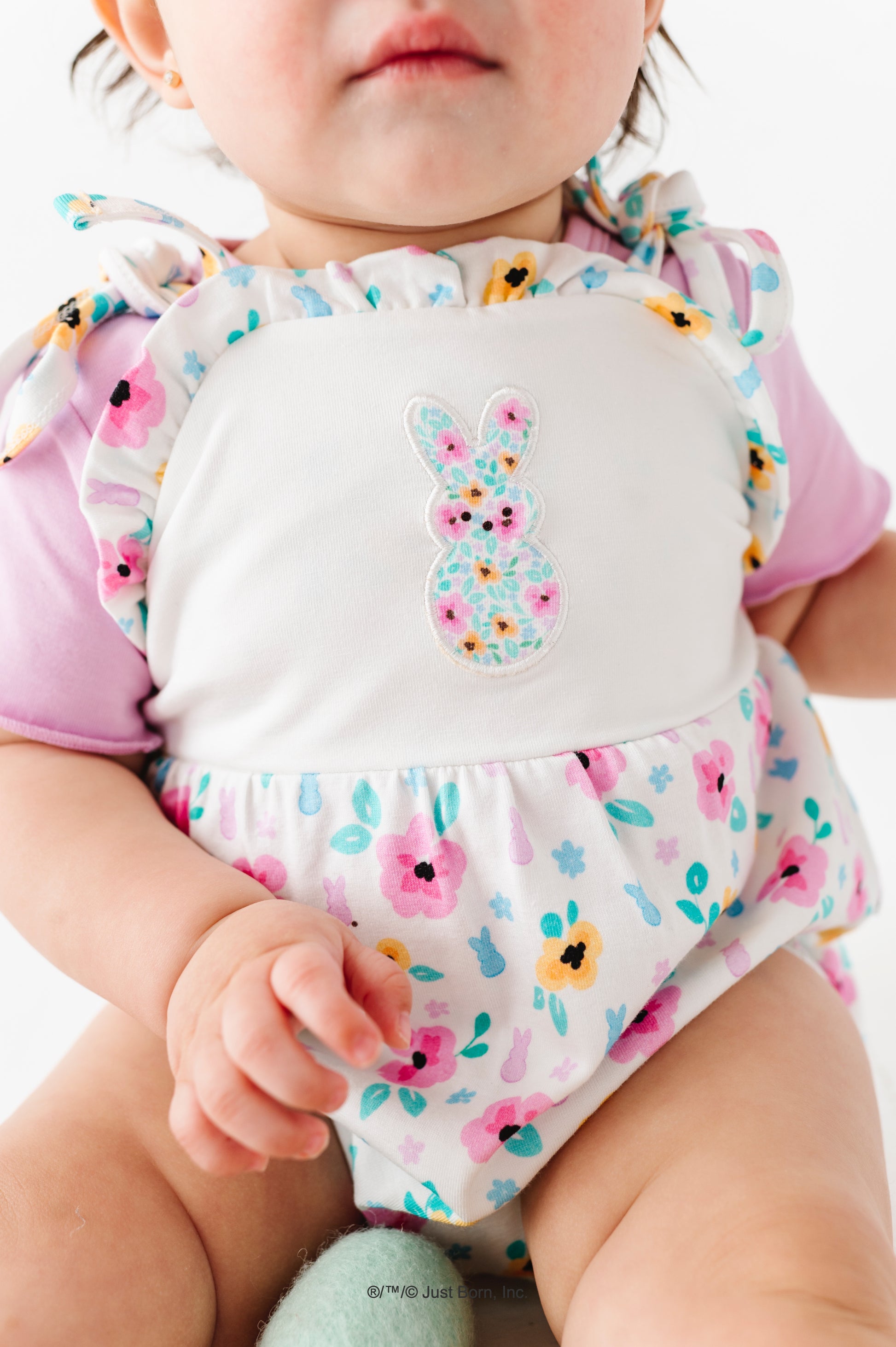 Baby wearing a colorful PEEPS® Easter outfit with a lavender bamboo tee underneath 