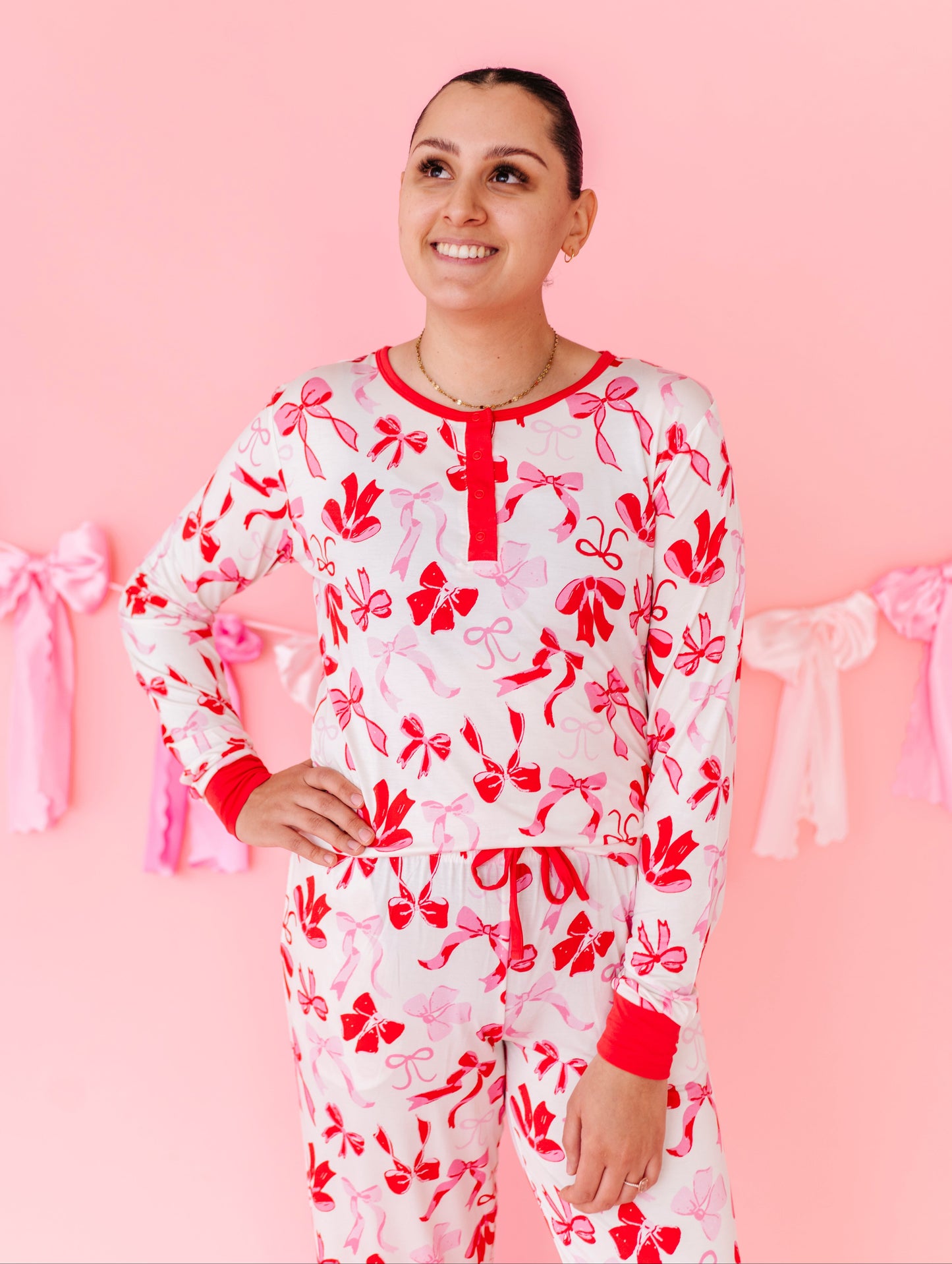 Woman wearing Blushing Bows bamboo pajama set with red and pink bow print