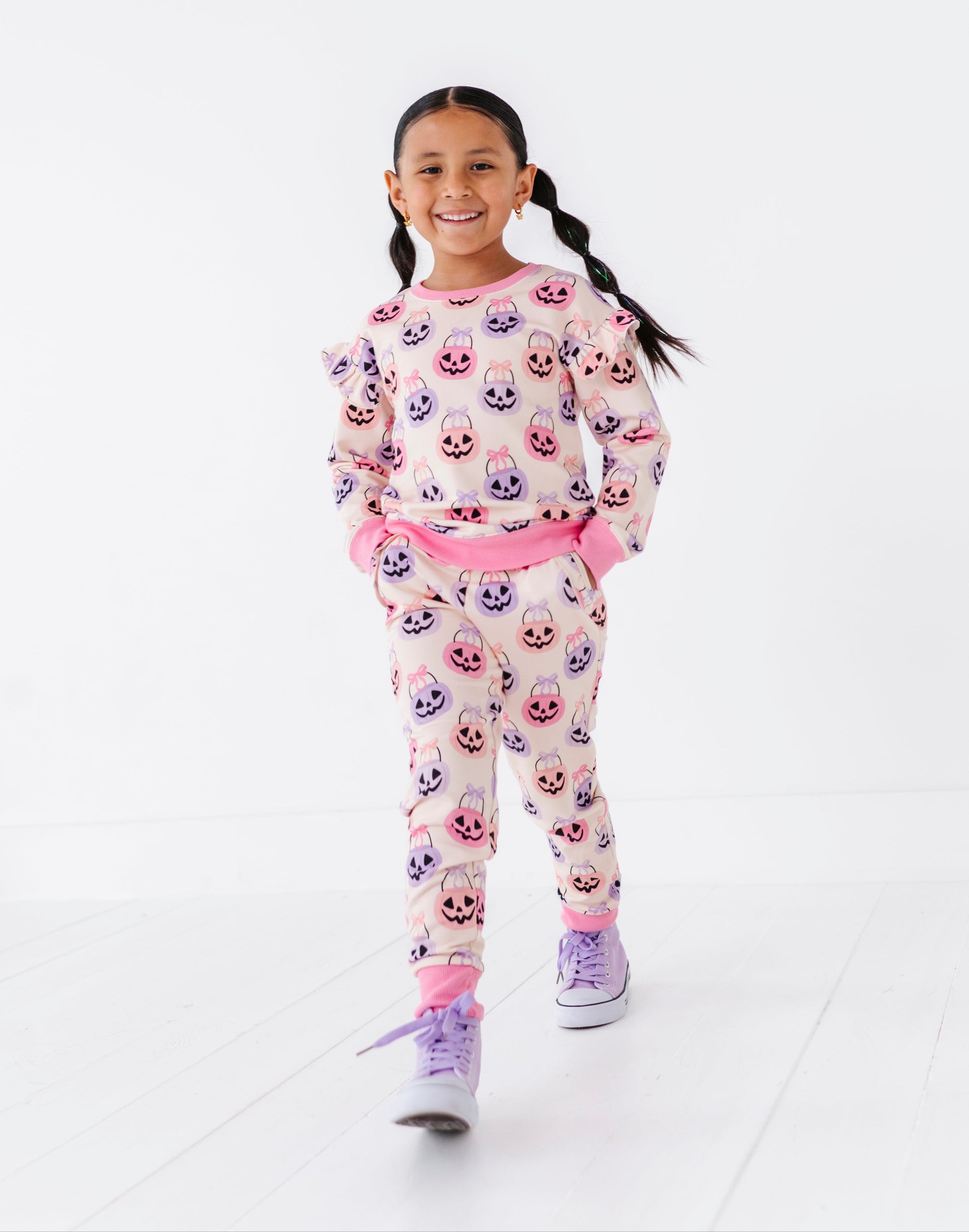 Young girl wearing a bamboo Halloween jogger set with a white background