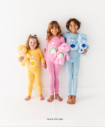 Kids matching Care Bears pajamas featuring Cheer Bear and rainbow design
