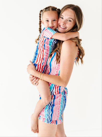 Mama and daughter wearing matching colorful bamboo short sets against a white background