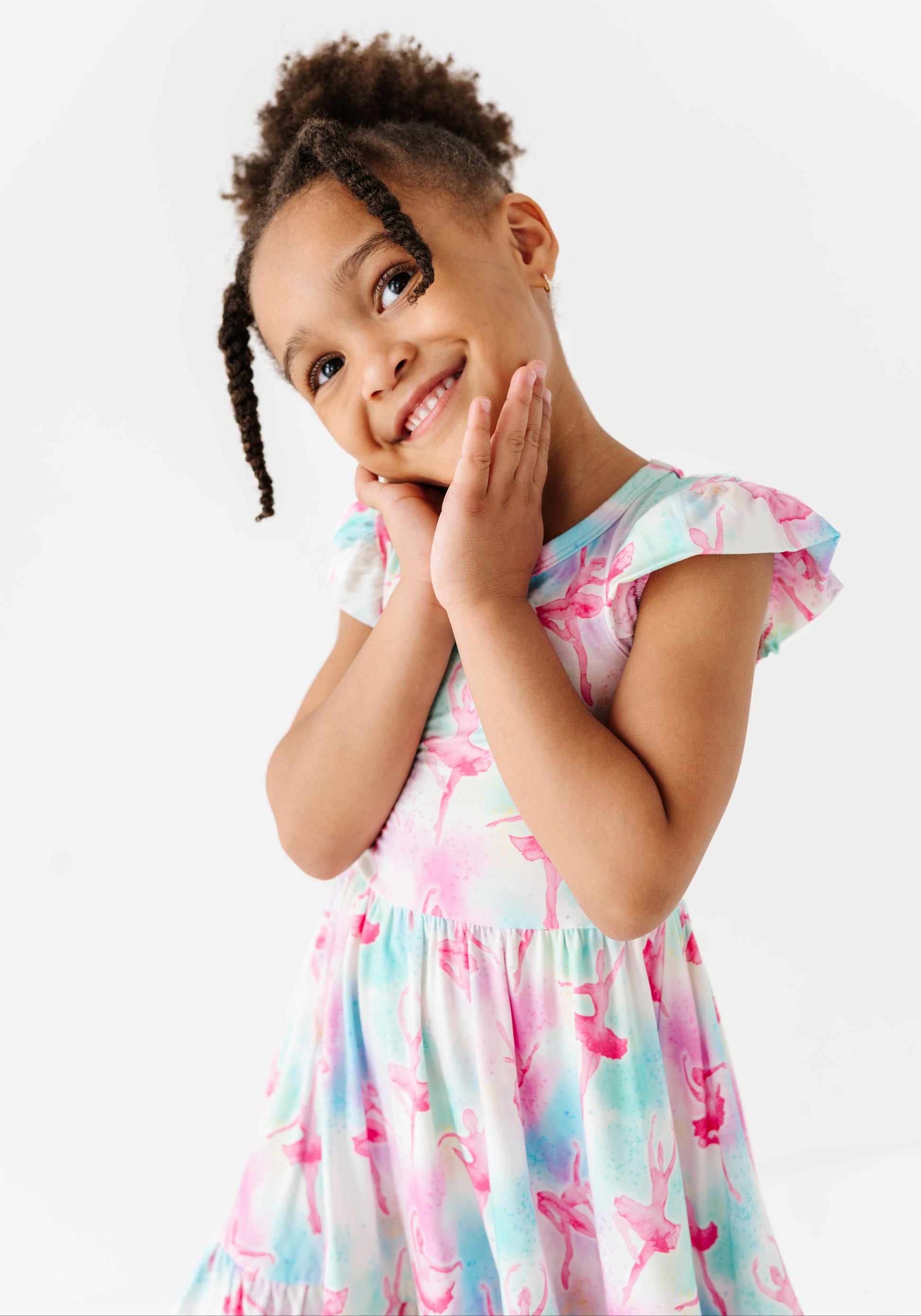 Young girl wearing a bamboo dress featuring watercolor ballerinas with a white background