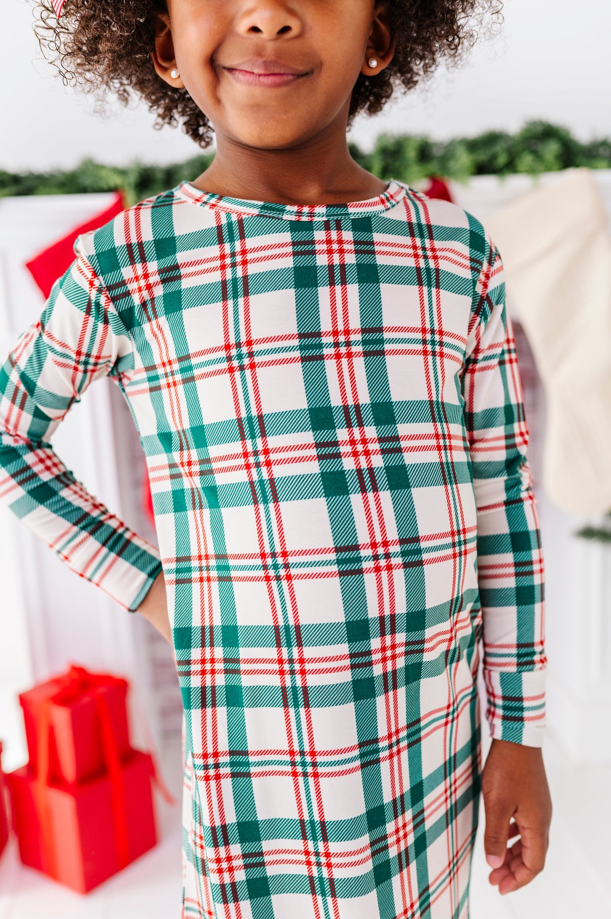 A close-up detail shot of a bamboo nightgown in a classic Christmas plaid print