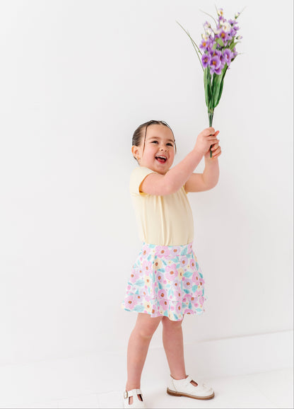 Child holding a bouquet of flowers against a white background