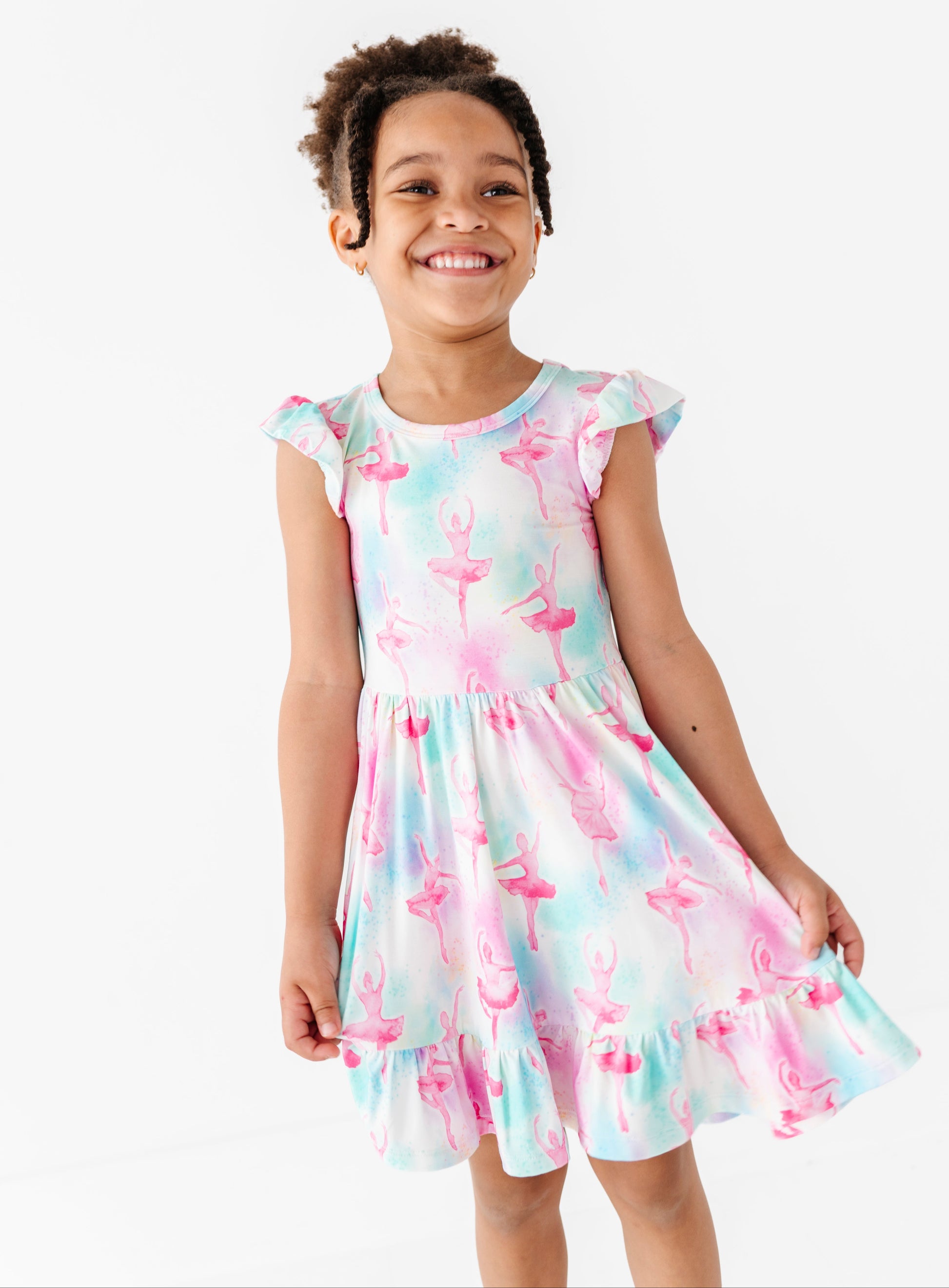 Young girl wearing a watercolor ballerina dress on a white background