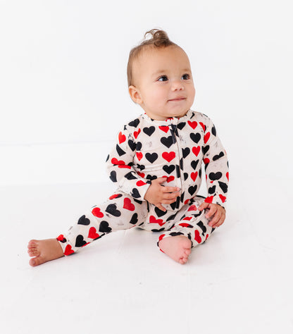 Baby sitting in King of Hearts convertible romper with soft bamboo fabric