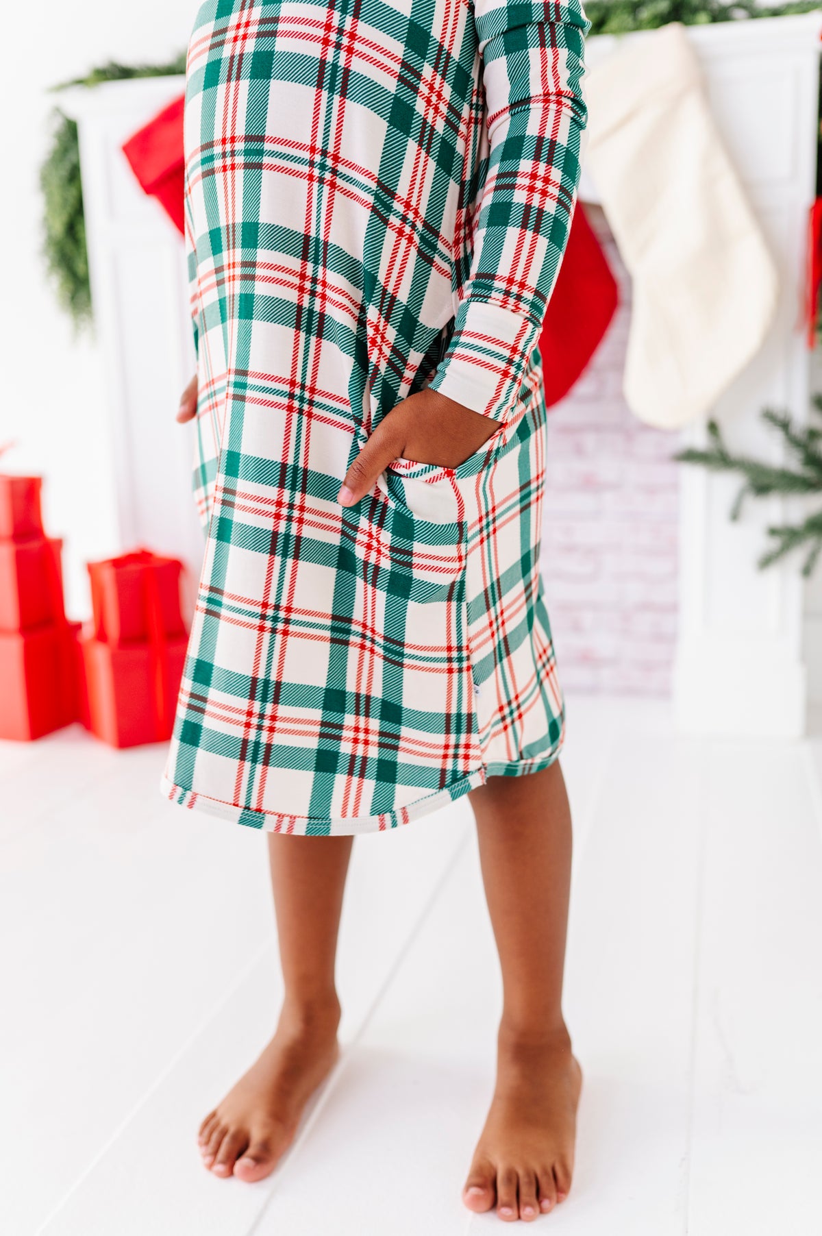 A close-up photo of a bamboo nightgown in a classic Christmas plaid print 